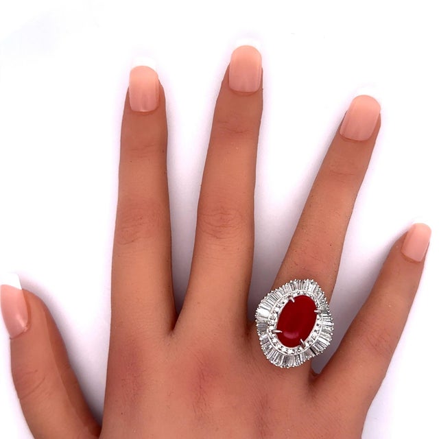 Exquisite craftsmanship. This fashion ring features a captivating coral, radiating vibrant red hues. Encircling the coral...