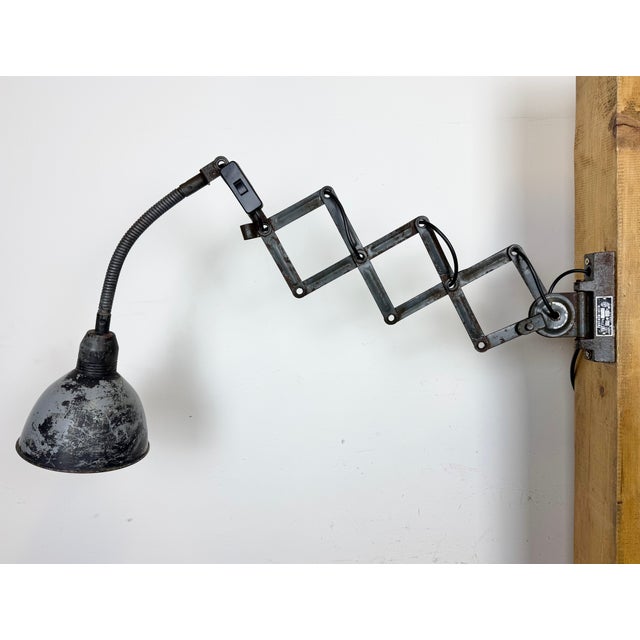 This vintage industrial adjustable gooseneck grey scissor wall light was produced by Elektroinstala Dečín in former...