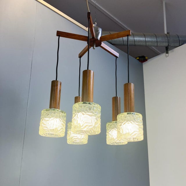 A beautiful ceiling light with the typical design and materials of the mid-century era. A particular highlight is the use...