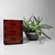 A compact Japanese storage cabinet inspired by traditional tansu design, with three drawers, warm reddish-brown wood and...