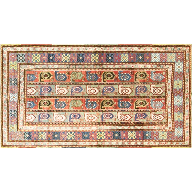 Distinguished by its refined vertical panel design. The field is composed of repeating boteh (paisley) motifs arranged in...