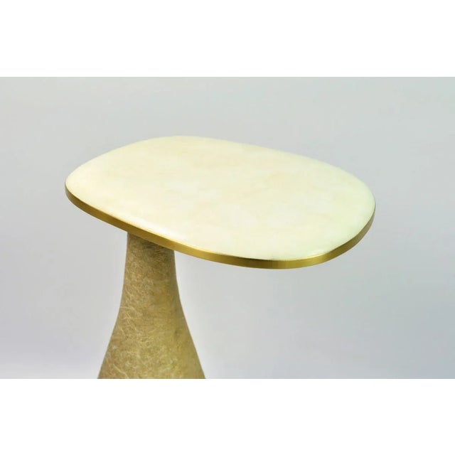 White rock crystal marquetry top with brass trims, gilded glass fiber base.