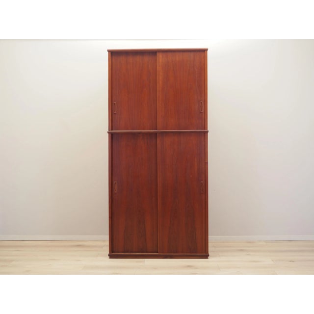 The wardrobe was made in the 1970s, Danish production. The structure is covered with teak veneer. The surface has been...