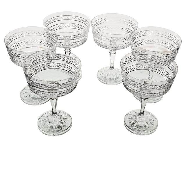 Exquisite and cold to the touch, each cut of glass speaks softly of restraint and ritual. Their scalloped rims catch the...