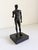 A Metropolitan Museum of Art reproduction of a standing male Greco-Roman athlete sculpture. The classical male figure is...