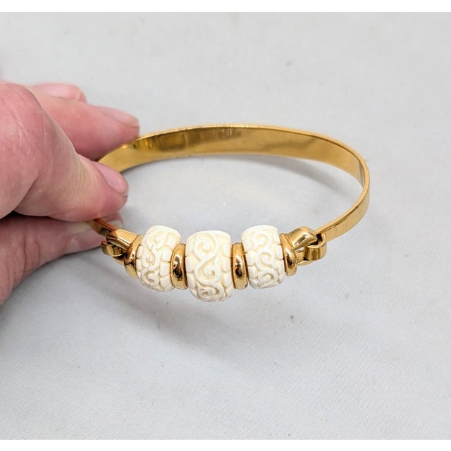 1970s Vintage Signed Crown Trifari Goldtone Carved Faux-Ivory Cuff Bracelet For Sale - Image 5 of 12