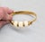 1970s Vintage Signed Crown Trifari Goldtone Carved Faux-Ivory Cuff Bracelet For Sale - Image 5 of 12
