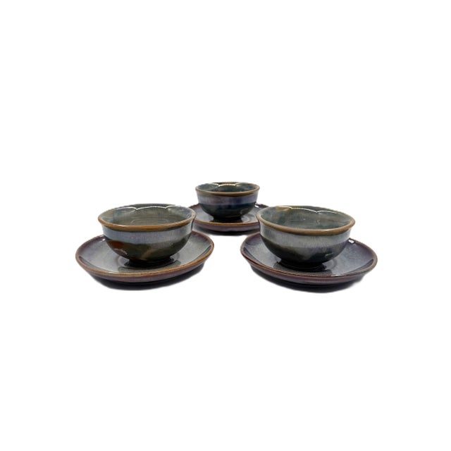 A stunning hand-painted Bat Trang ceramic tea set designed for four, made by the Gia Oanh pottery studio in Vietnam’s...