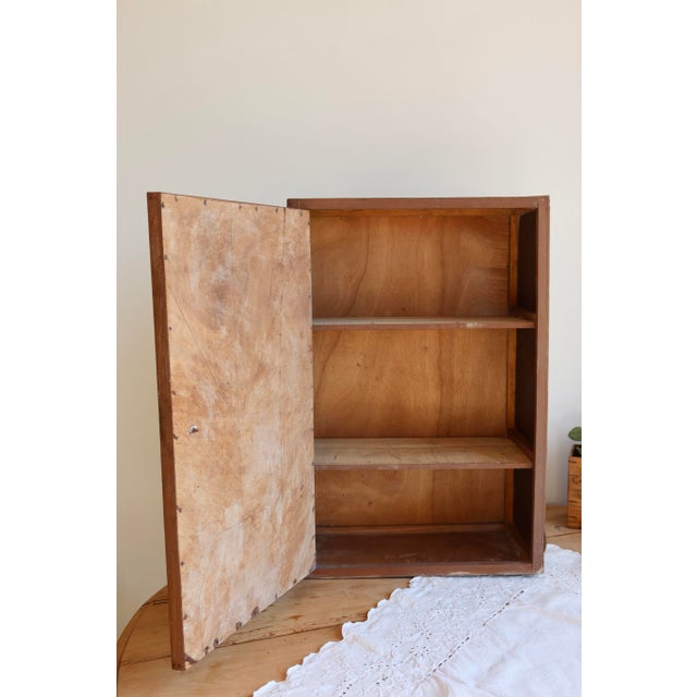 Small antique wooden storage unit, finished with its original brown paint and a soft, authentic patina. Compact design...