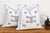 Sold as a matching pair, these handcrafted Moroccan cactus silk pillows feature a central bowtie medallion and crossed-X...