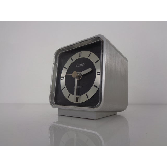 Kienzle table clock made of brushed aluminum from the 1970s. The clock comes in its original packaging and with...