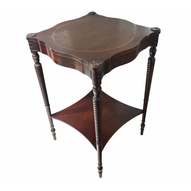 Add a classic look to your decor with this fine mahogany side table from the 1940s with slender tapered legs, lower...
