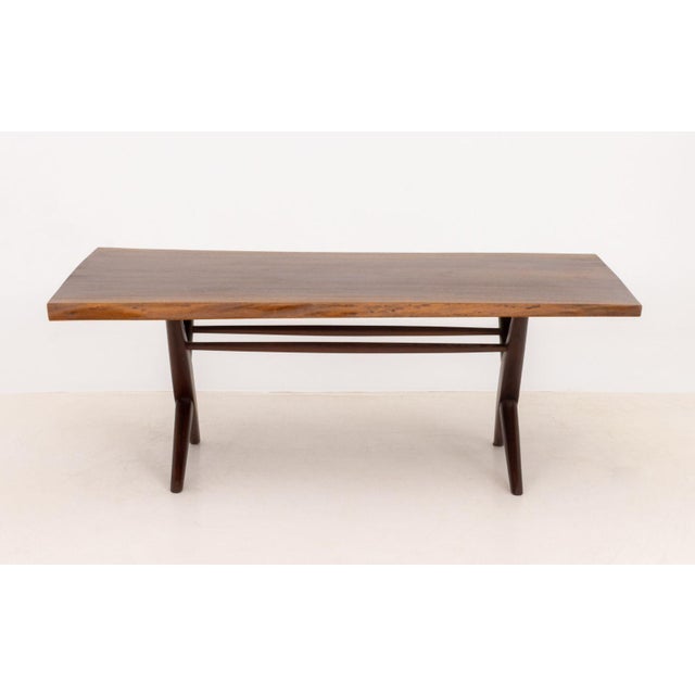 George Nakashima (American, 1905-1990) American Walnut Slab Top Coffee Table, 1962, on four turned wood legs. 17" H x 46"...