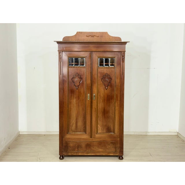 For sale is this magnificent wardrobe from the Gründerzeit period, distinguished by its elegant crown, artistic carvings,...