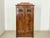 For sale is this magnificent wardrobe from the Gründerzeit period, distinguished by its elegant crown, artistic carvings,...