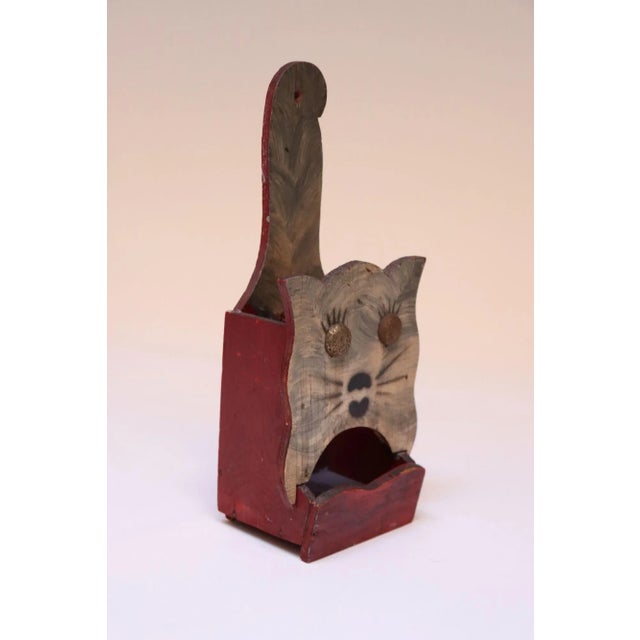 Hand-carved Folk Art matchbook holder with attached metal eyes and original hand-painted details (ca. 1940s, USA). Primary...