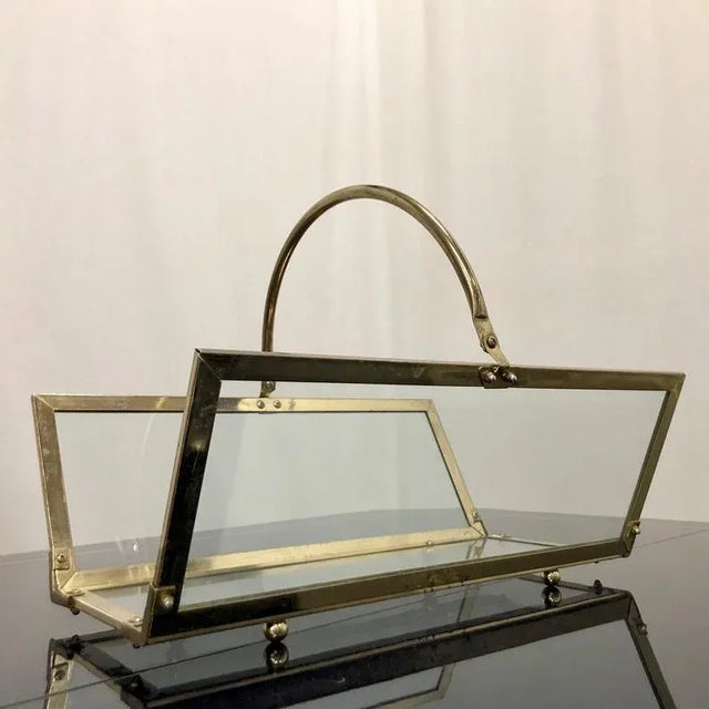 Large magazine holder from the mid century era. Brass plated frame holding 3 glass panes for the sides and bottom....