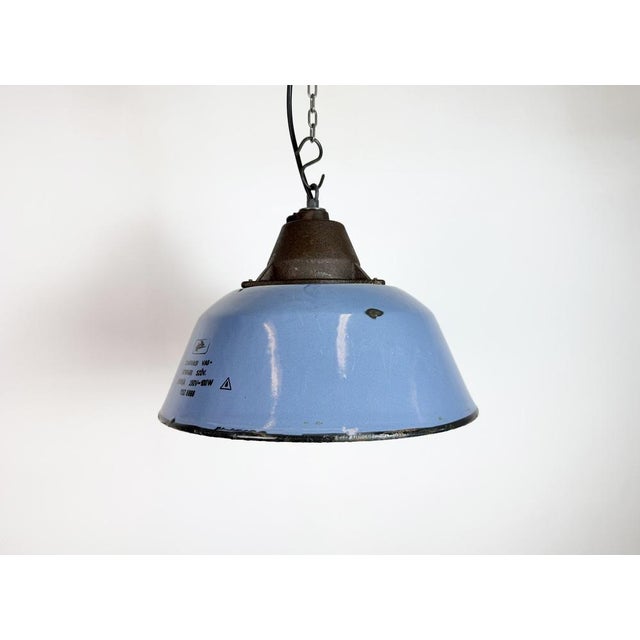 Industrial hanging lamp manufactured by Szarvasi Vas - Fém in Hungary during the 1960s. It features a blue enamel shade...