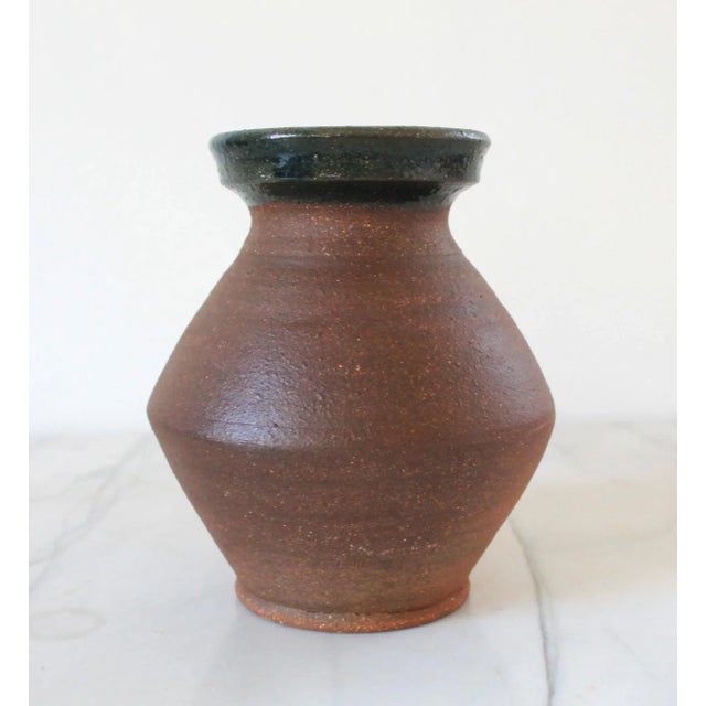 Vintage two tone brown studio art pottery vase or vessel with dark blue rim. Stamped "SK" on bottom. Minor age wear. No...