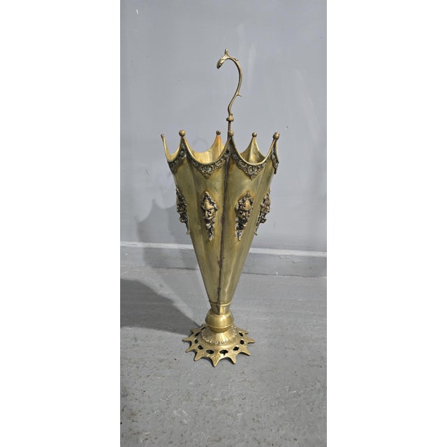 Brass umbrella stand with devil masks to the sides, overall great original condition. 26" high