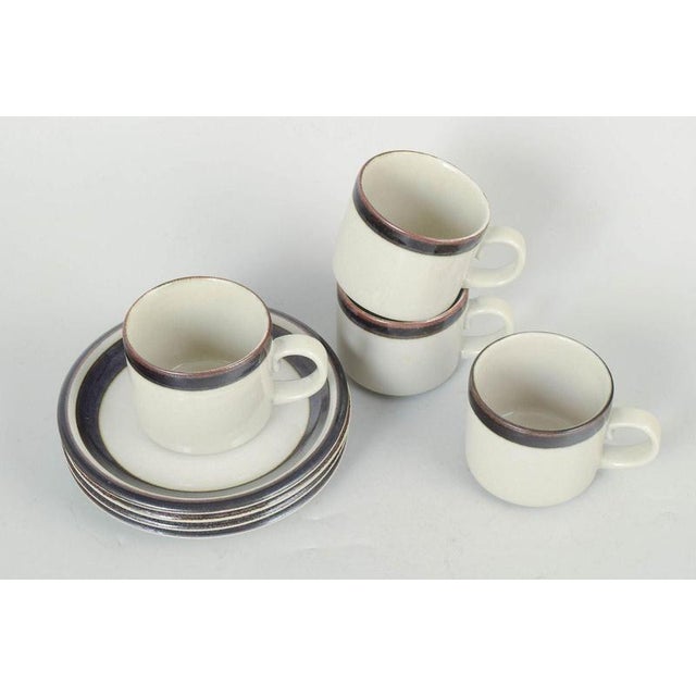 Arabia Karelia, set of four tea cups with matching saucers. Classic stoneware set consisting of four tea cups and four...