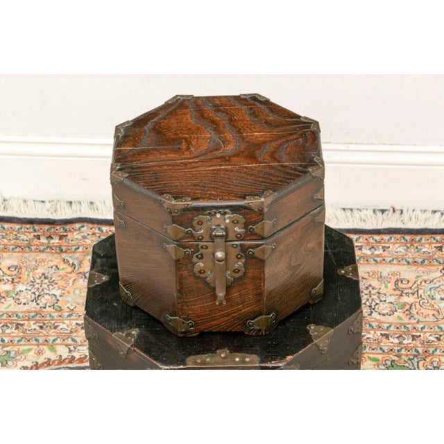 A Set of Three Lift Top Asian Stacking Storage Boxes With Brass Fittings A set of three lift top Asian wooden storage...