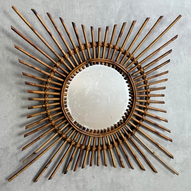 1950s rattan sunburst mirror. The mirror is original, handcrafted in the south of France.
