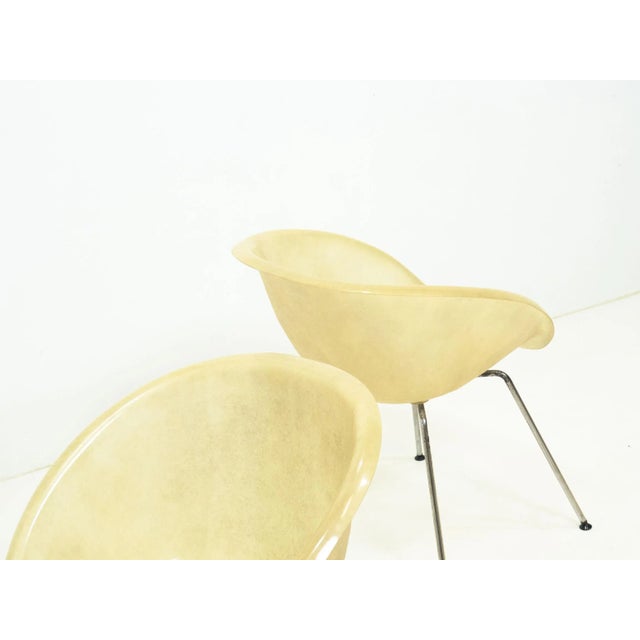 Set of two vintage fiberglass shell chairs. The frames are made of chrome coated steal with a fair amount of patina/wear,...