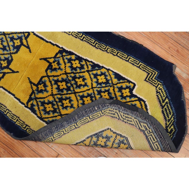 An early 20th century Tibetan horse cover textile rug in blue and yellow, circa 1900, measures: 2'1" x 4'9".