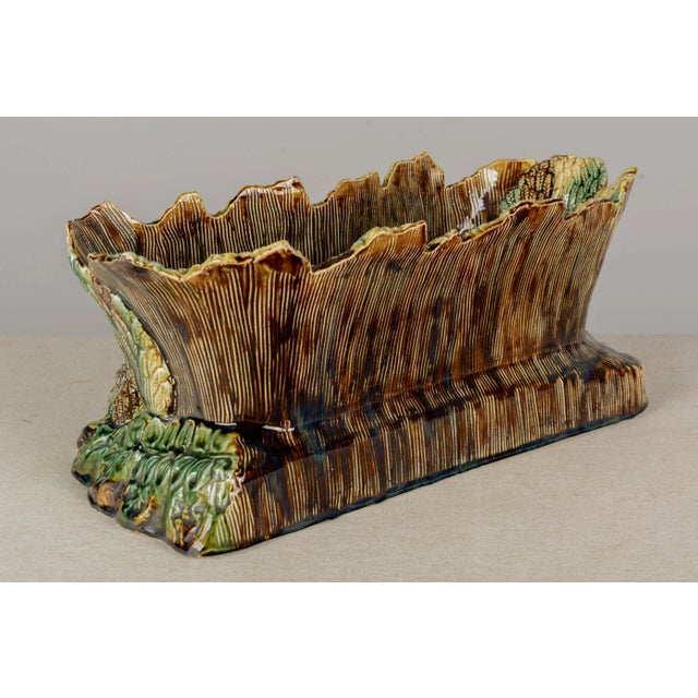 A large English Majolica glazed ceramic jardinière, or planter, oblong shape depicting a sleeping maiden in a field of...