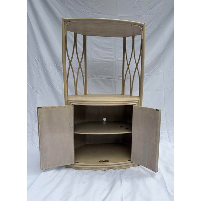 Charming vintage 1970s/1980s Postmodern corner hutch crafted with beautifully textured pencil reed and bent rattan...