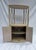 Charming vintage 1970s/1980s Postmodern corner hutch crafted with beautifully textured pencil reed and bent rattan...