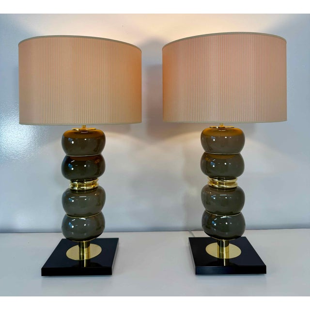 Elegant pair of table lamps produced in murano, italy. each lamp is composed of stacked, rounded elements in smoky grey...