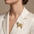 Elevate your accessory game with this exquisite pug dog brooch, meticulously crafted from 18k yellow gold and featuring a...