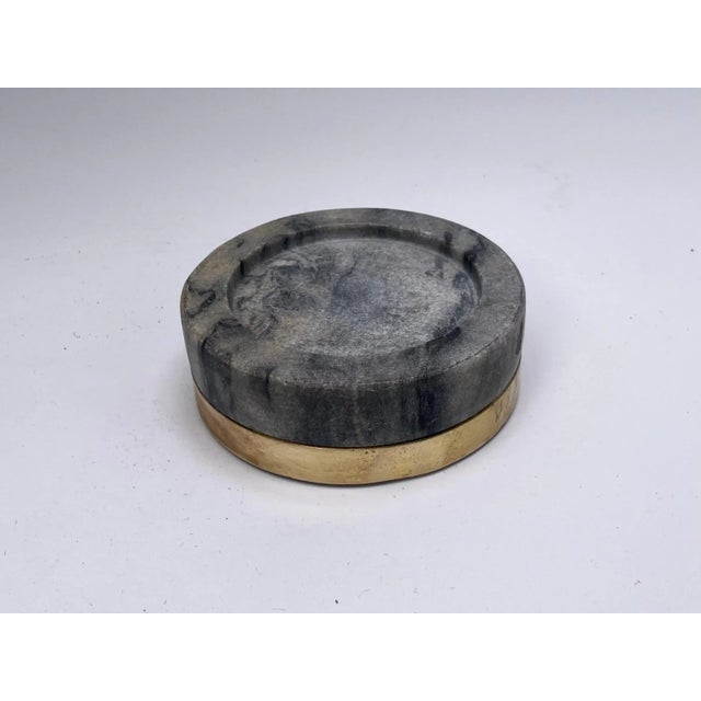 This vide Poche, ashtray is in marble and brass. The color is grey and gold. It has been made i, Italy circa 1950, and is...