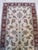 This ivory, beige, cream, and white runner is a hand knotted pile rug crafted from natural wool. It represents the classic...