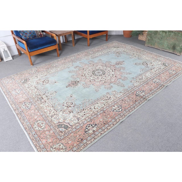 Enhance your living space with this stunning vintage handmade Turkish wool rug from the 1970s. The soft ice blue hues,...