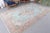 Enhance your living space with this stunning vintage handmade Turkish wool rug from the 1970s. The soft ice blue hues,...