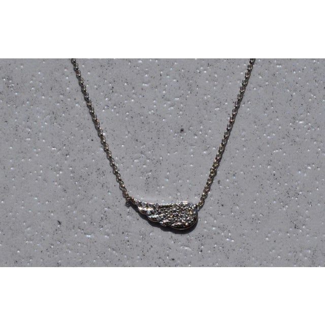 The Wing: White Gold Bracelet with Diamond Wings. The bracelet features a thin chain link style bracelet centering on a...