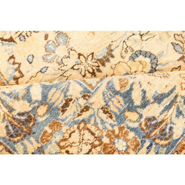 An atypical late 19th century Persian Antique Tabriz rug, the camel field with an unusual scattering of floral groups with...