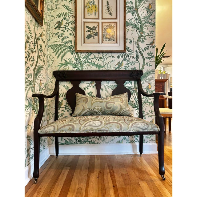 This is a mahogany settee in the classic or Empire style with updated upholstery. The classic lines are decorated in each...