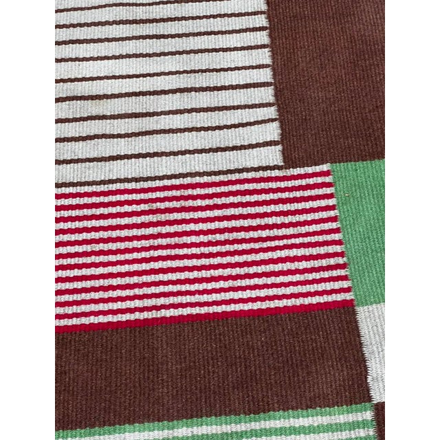 Beautiful and generously sized Mid-Century Modern wool rug from 1960s Czechoslovakia, featuring a striking geometric...