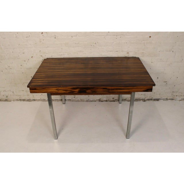 This stunning extendable table was made with a rare macassar wood. This piece was made by the German company Fritz...