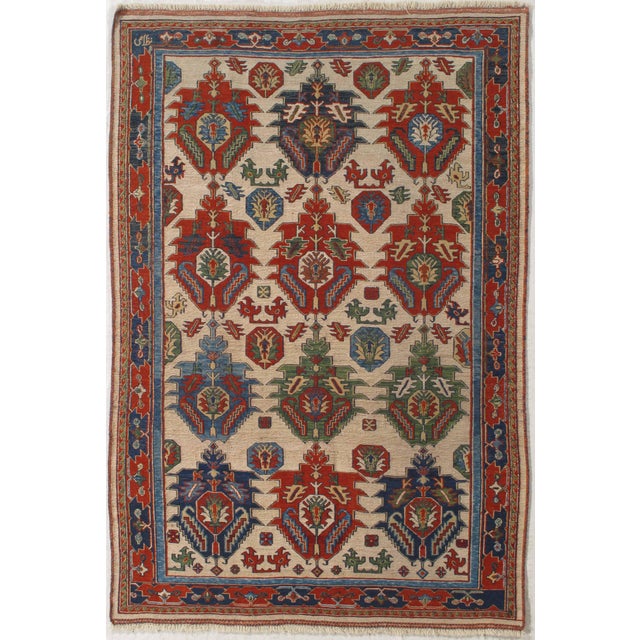 Hand-knotted Caucasian Sumak rug featuring a striking all-over geometric design on an ivory field. The composition is...