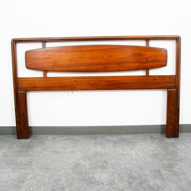 Handsome and timeless mid century Modern Queen size headboard crafted from wood with a rich finish. Neat cut out design...