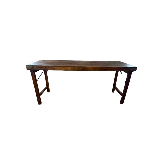 Crafted from reclaimed wood, this table features a beautifully distressed tabletop with rich tonal variations, prominent...