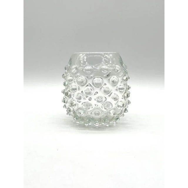 This charming knobbly vase was traditionally handcrafted on Murano, the famous glass island near Venice. with its bulbous...