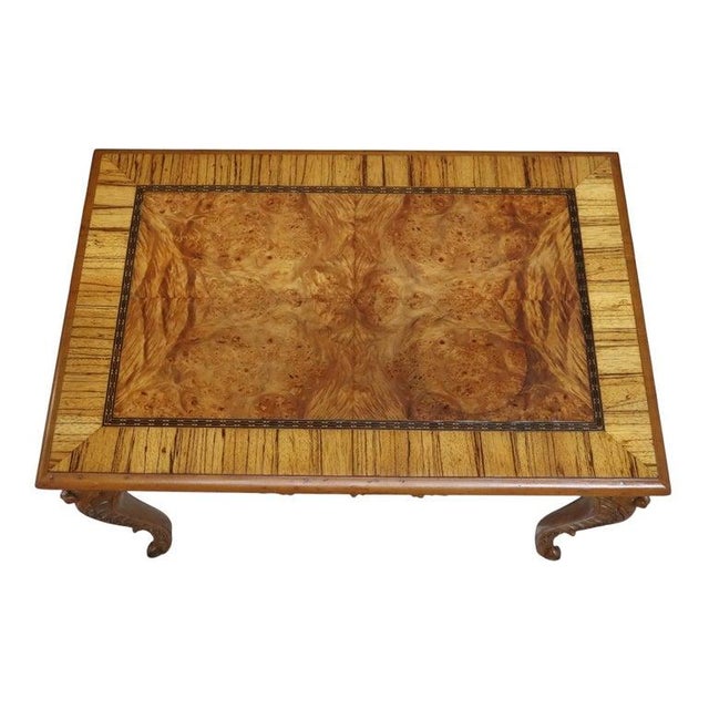 This exquisite antique low table, dating to approximately 1930, features a rectangular top crafted from burl wood,...
