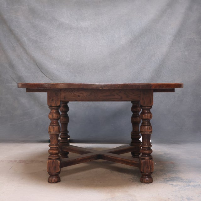 This 19th Century English oak Baroque round dining table features a richly patinated circular top supported by four boldly...