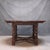This 19th Century English oak Baroque round dining table features a richly patinated circular top supported by four boldly...
